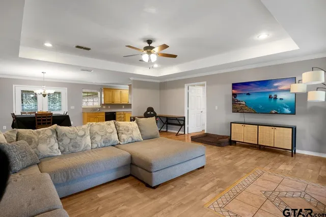 a living room with furniture and a chandelier