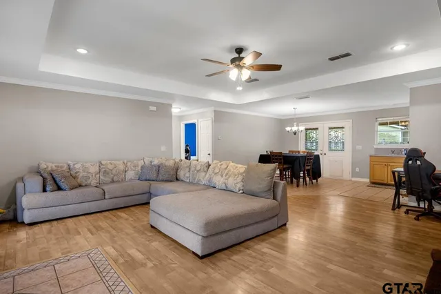 a living room with furniture and wooden floor