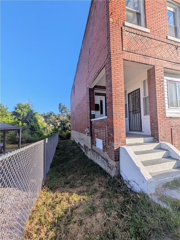 82 Harlem Avenue McKees Rocks, PA 15136 - Photo 2 of 27 a view of a house with wooden fence