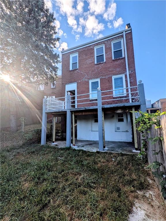 82 Harlem Avenue McKees Rocks, PA 15136 - Photo 23 of 27 a brick house that has a small yard and large trees
