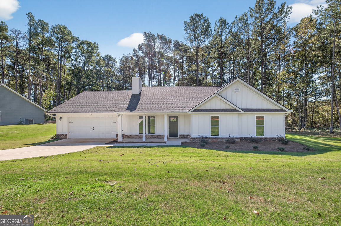51 Brockton Way, Unit 2 Winder, GA 30680 - Photo 1 of 38 a view of a house with a big yard and large trees