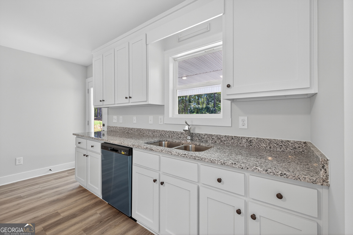 51 Brockton Way, Unit 2 Winder, GA 30680 - Photo 14 of 38 a kitchen with granite countertop white cabinets and a window