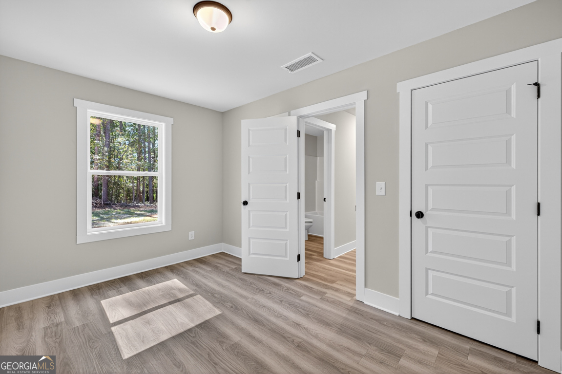 51 Brockton Way, Unit 2 Winder, GA 30680 - Photo 17 of 38 a view of livingroom with hardwood floor and window