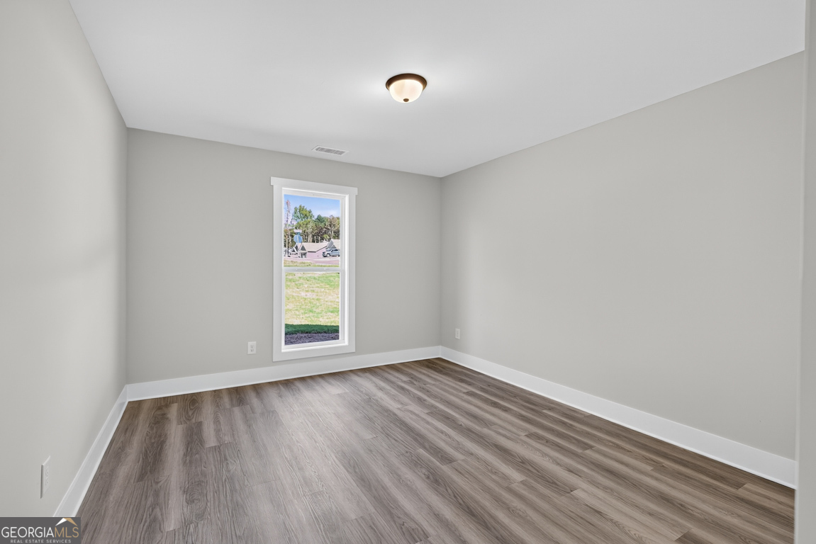 51 Brockton Way, Unit 2 Winder, GA 30680 - Photo 20 of 38 a view of empty room with wooden floor and fan