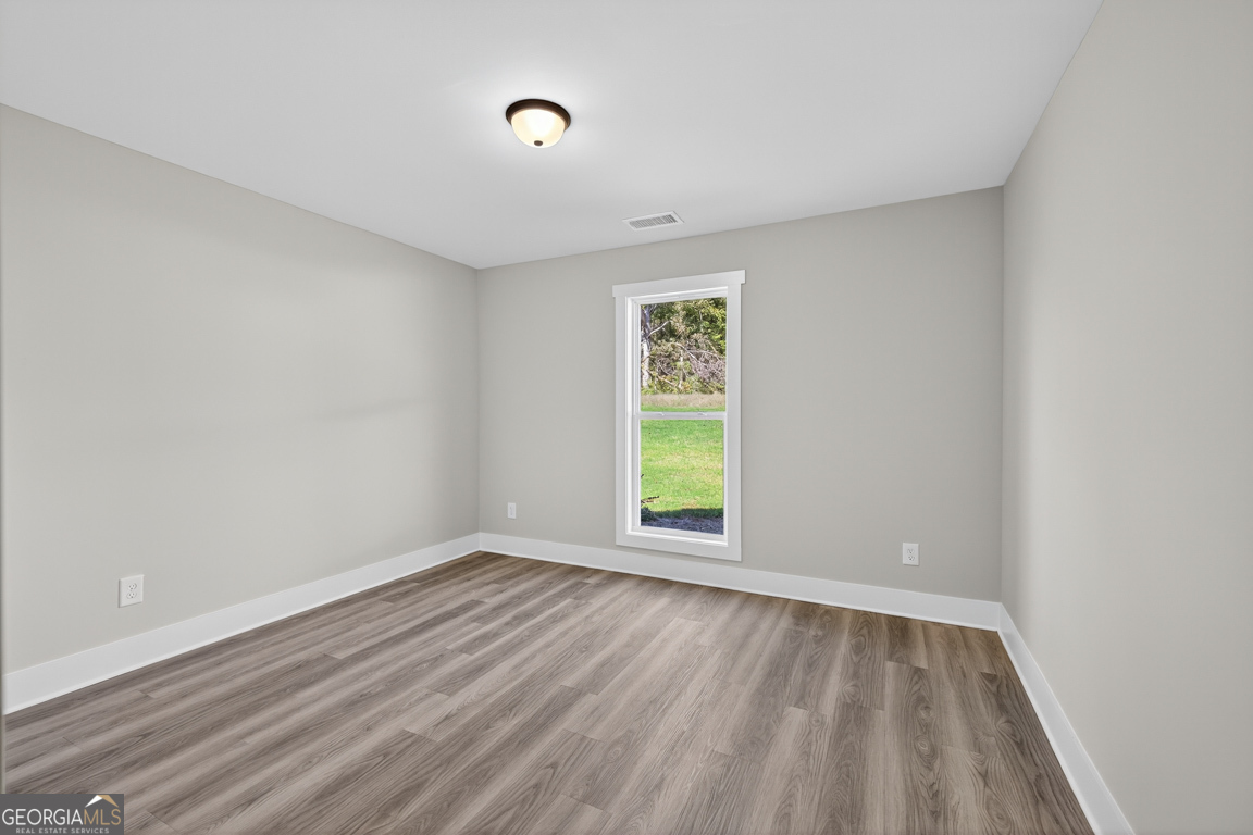 51 Brockton Way, Unit 2 Winder, GA 30680 - Photo 22 of 38 wooden floor in an empty room with a window