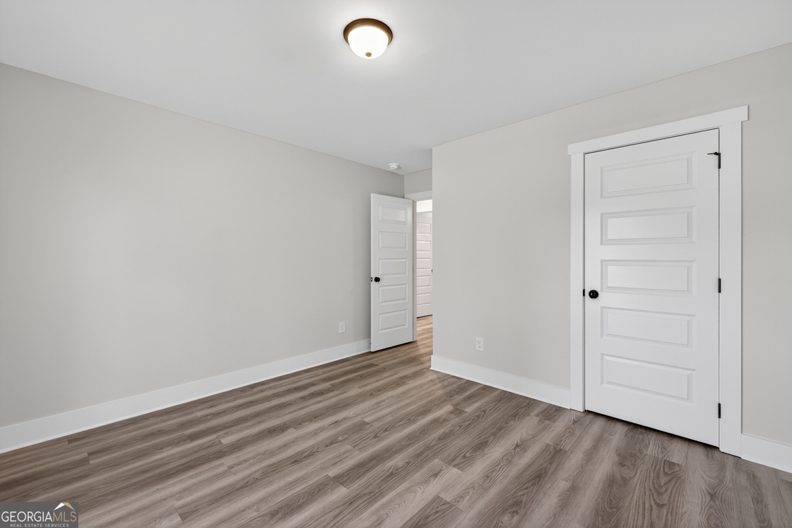 51 Brockton Way, Unit 2 Winder, GA 30680 - Photo 23 of 38 a view of an empty room with wooden floor