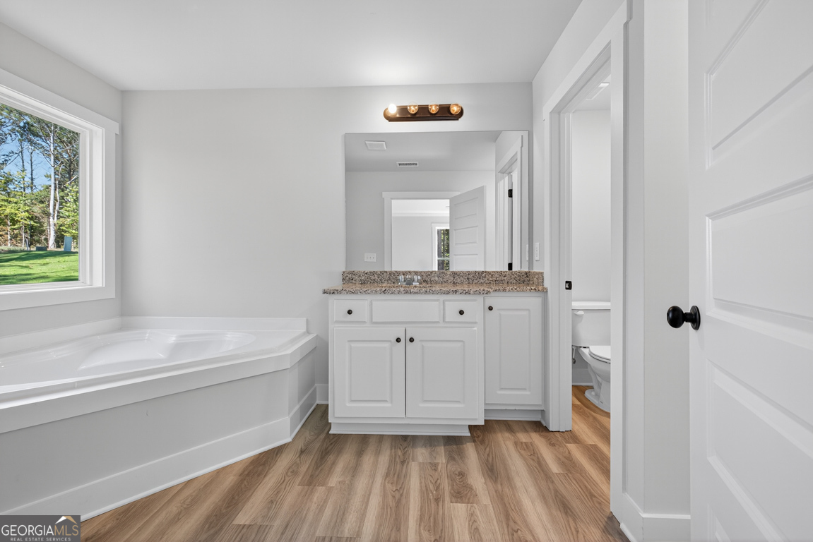 51 Brockton Way, Unit 2 Winder, GA 30680 - Photo 29 of 38 a bathroom with a sink a mirror and a bathtub