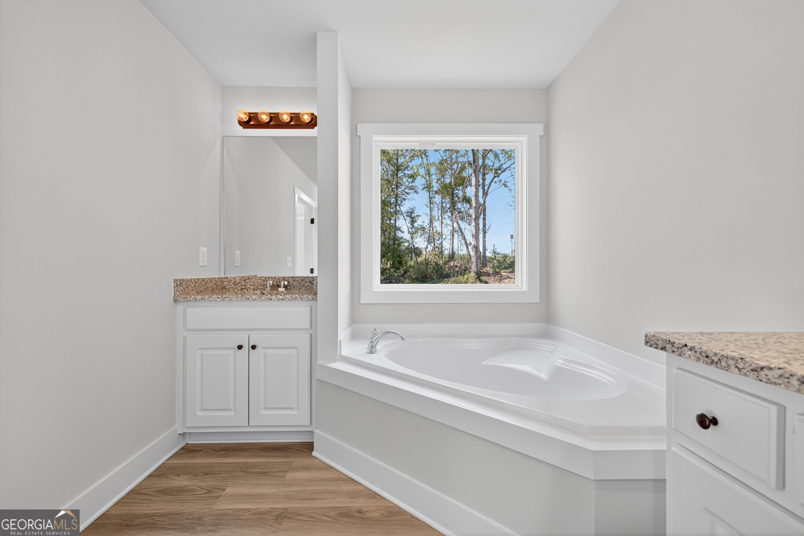 51 Brockton Way, Unit 2 Winder, GA 30680 - Photo 30 of 38 a bathroom with a tub sink and mirror