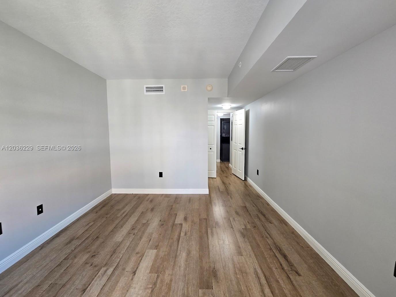 888 Douglas Road, Unit 605 Coral Gables, FL 33134 - Photo 17 of 21 a view of empty room with wooden floor