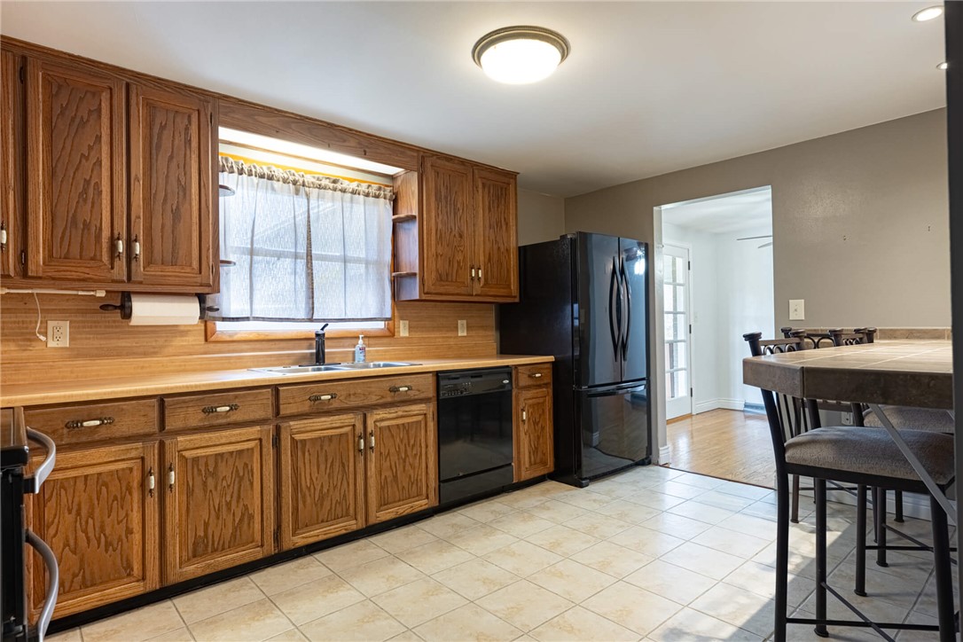 5235 West Ridgewood Road Springfield, OH 45503 - Photo 8 of 32 This spacious kitchen offers ample cabinetry, a dedicated dining area, and practical tile flooring.