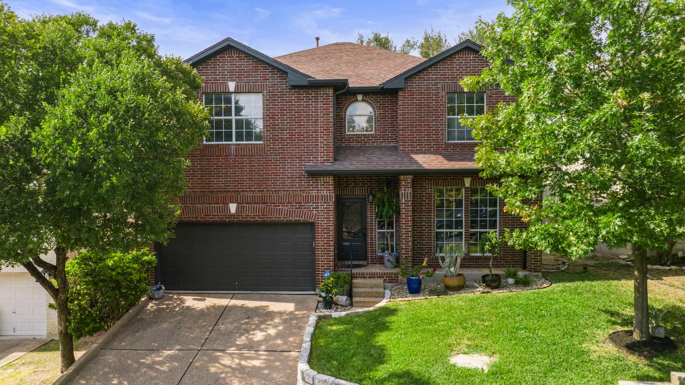 a front view of a house with garden