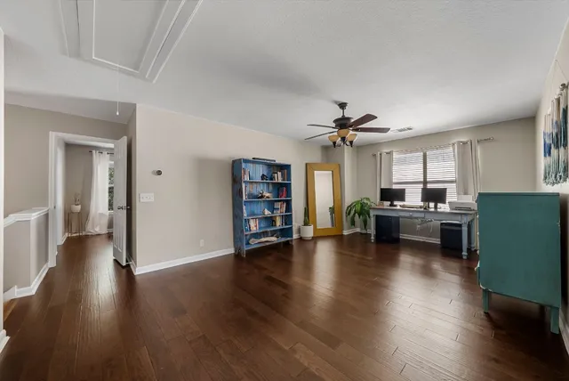 a view of a livingroom with furniture and a kitchen