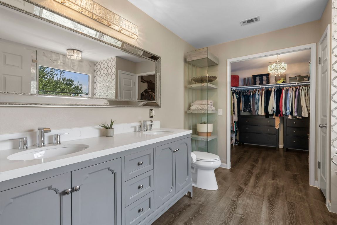 4104 Seldalia Trail Austin, TX 78732 - Photo 20 of 40 a bathroom with a double vanity sink toilet and shower