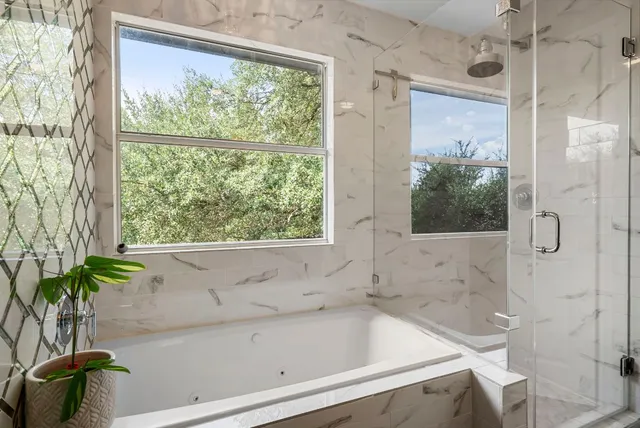 a bath tub sitting next to a window