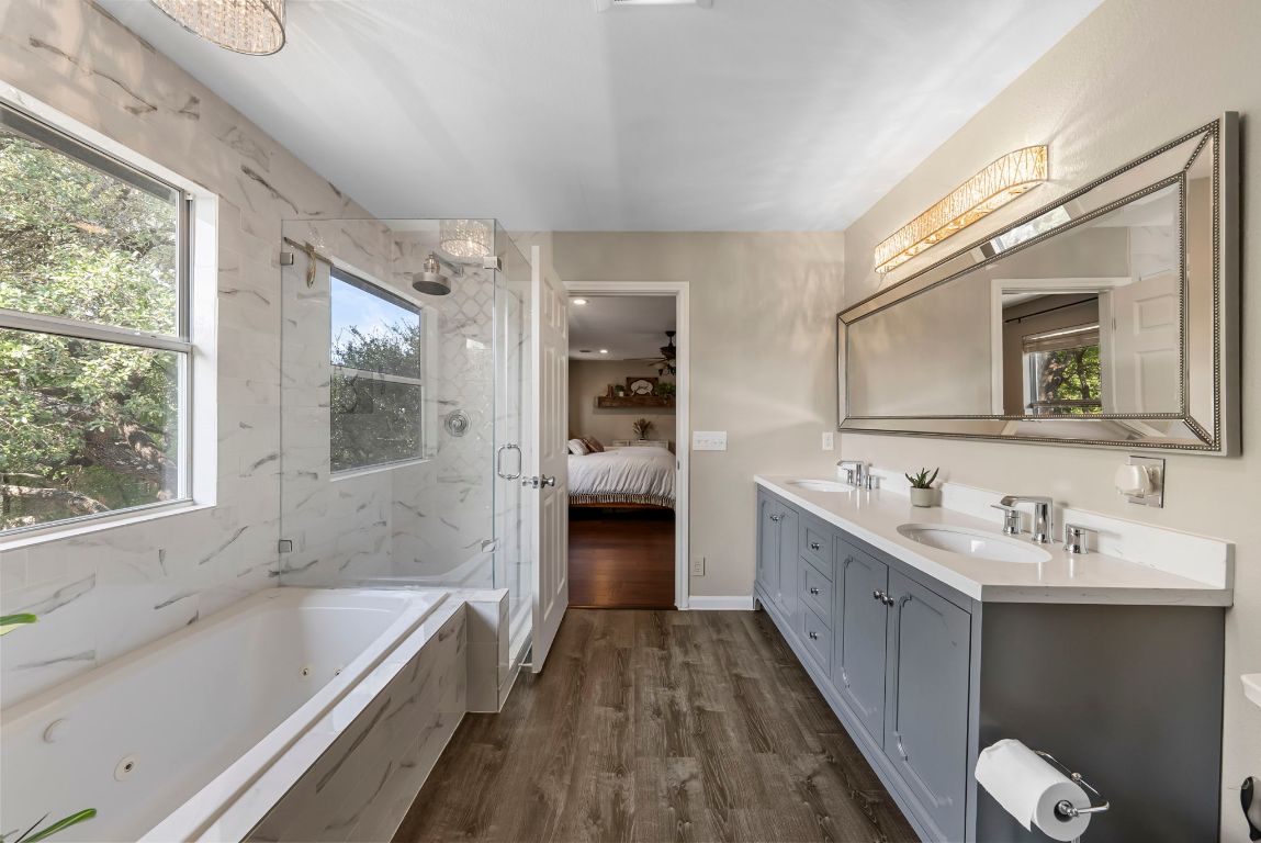 4104 Seldalia Trail Austin, TX 78732 - Photo 22 of 40 a bathroom with a double vanity sink and mirror with bathtub