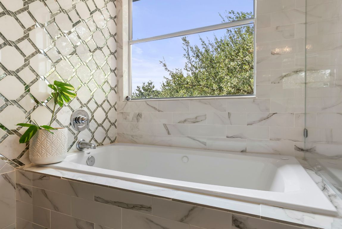 4104 Seldalia Trail Austin, TX 78732 - Photo 23 of 40 a bathroom with a bathtub and shower