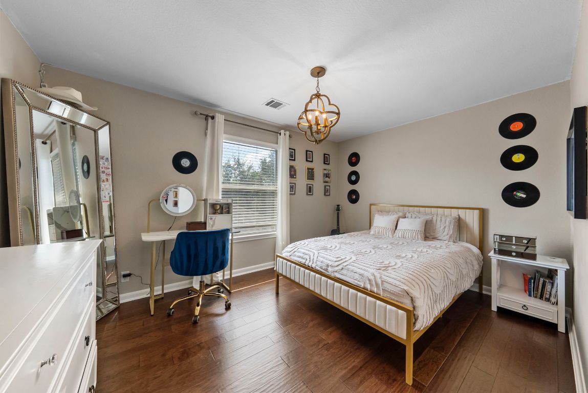 4104 Seldalia Trail Austin, TX 78732 - Photo 24 of 40 a bedroom with a bed and a desk next to a window
