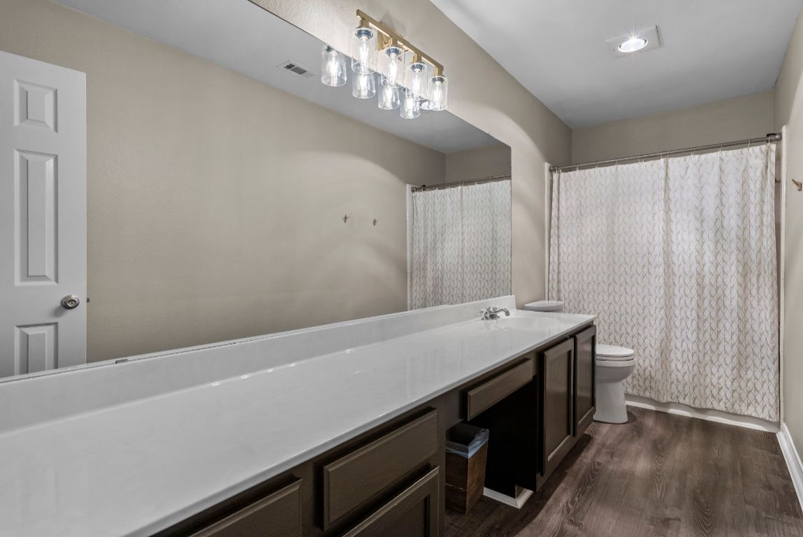 4104 Seldalia Trail Austin, TX 78732 - Photo 25 of 40 a bathroom with a sink and a mirror