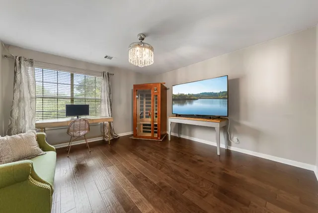 a living room with furniture and a wooden floor