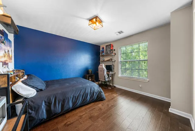 a bedroom with bed and a window