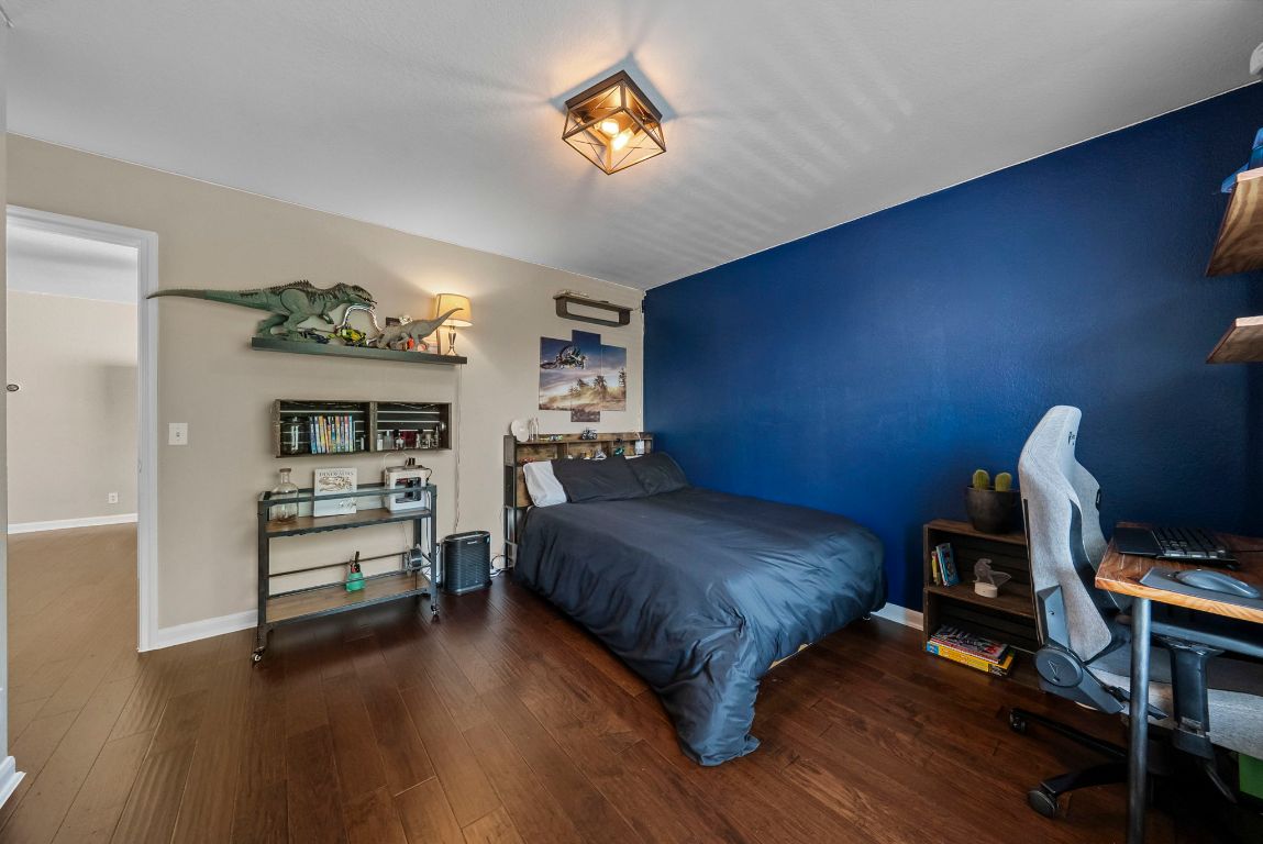 4104 Seldalia Trail Austin, TX 78732 - Photo 29 of 40 a bedroom with a bed and a chandelier