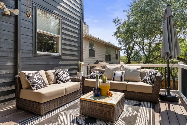 a view of a patio with couches chairs and a wooden floor
