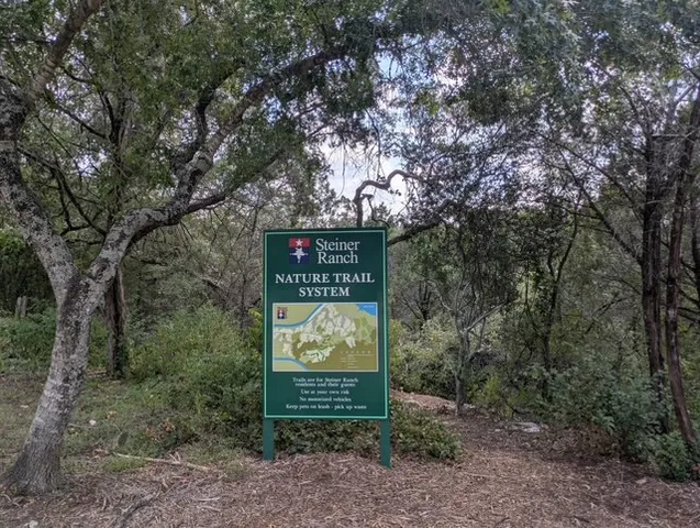 a sign that is sitting on a rock