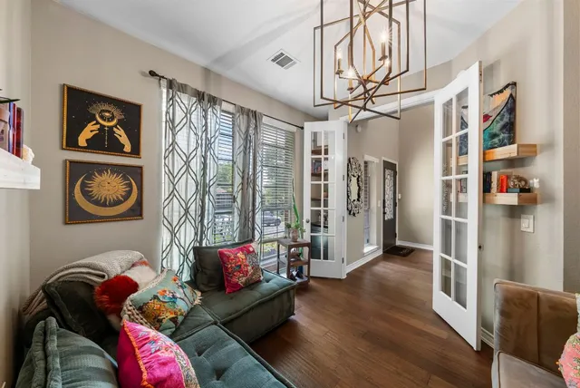 a living room with furniture and wooden floor