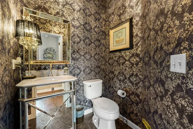 a white toilet sitting next to a bathroom sink