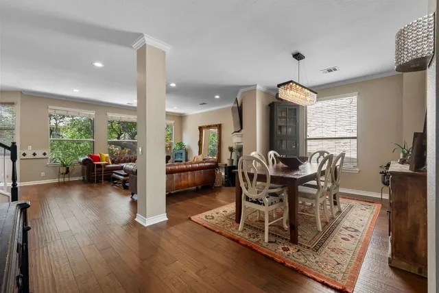 a view of a dining room with furniture and a large window