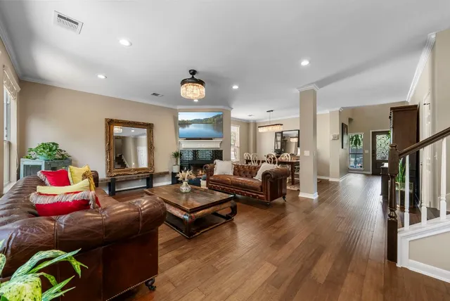 a living room with fireplace furniture and a wooden floor
