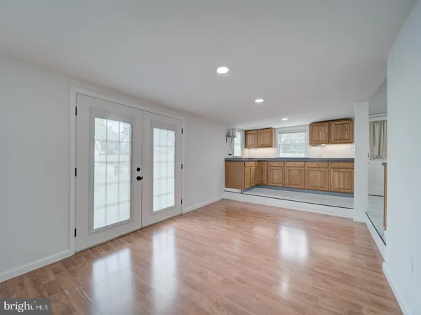 a view of a livingroom with wooden floor and a fireplace