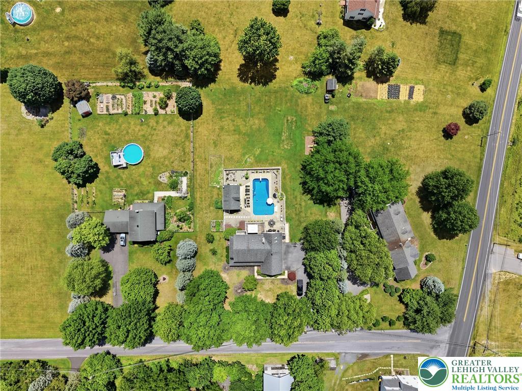 890 Lahr Road Nazareth, PA 18064 - Photo 59 of 71 An aerial perspective reveals a vast estate, complete with a sparkling in-ground pool and meticulously maintained gardens.