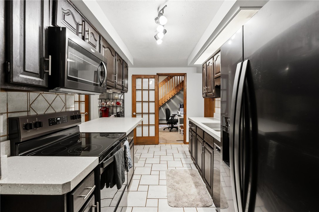 1940 Armstrong Road Fairborn, OH 45324 - Photo 26 of 48 This modern kitchen features sleek countertops and appliances, perfect for culinary endeavors.