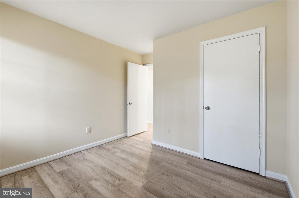 Margate Court, Unit A Sterling, VA 20164 - Photo 12 of 20 a view of an empty room with wooden floor