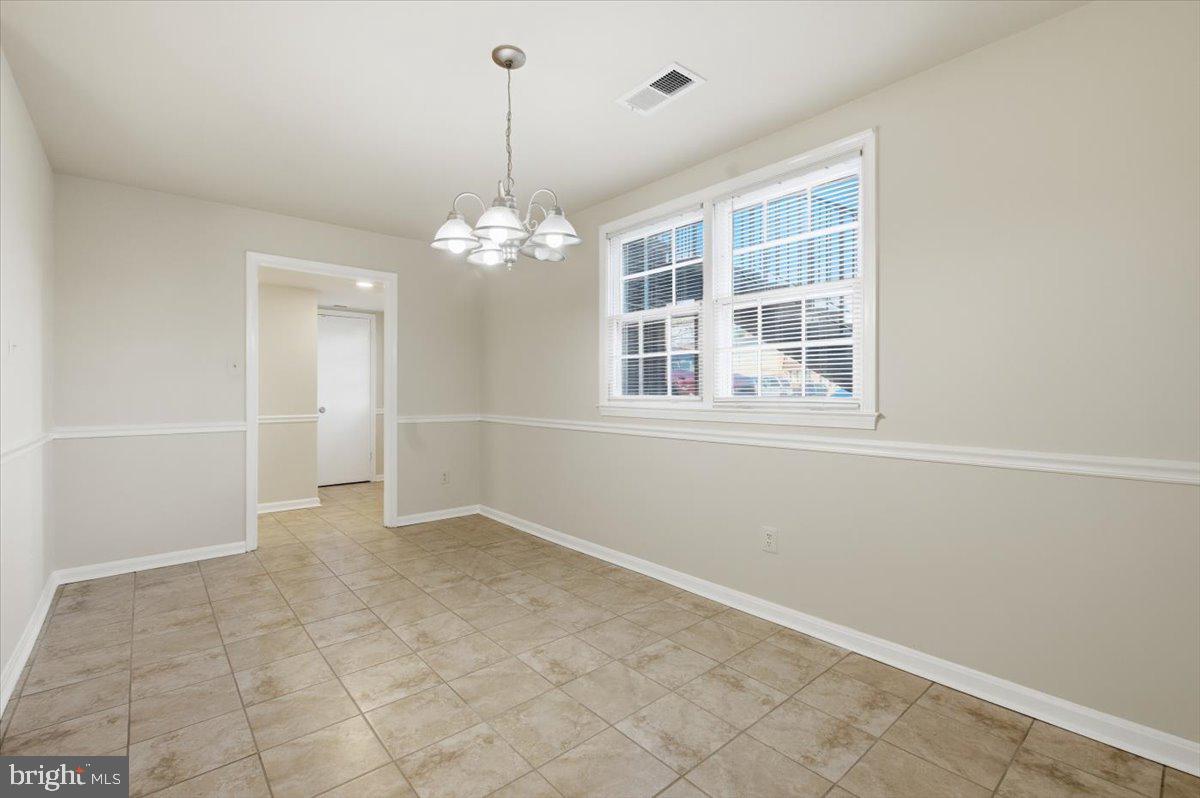 Margate Court, Unit A Sterling, VA 20164 - Photo 4 of 20 an empty room with chandelier and windows