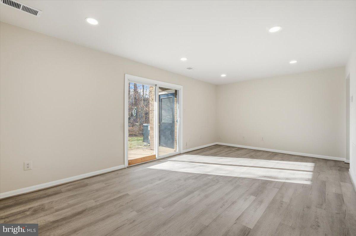 Margate Court, Unit A Sterling, VA 20164 - Photo 7 of 20 an empty room with wooden floor and windows