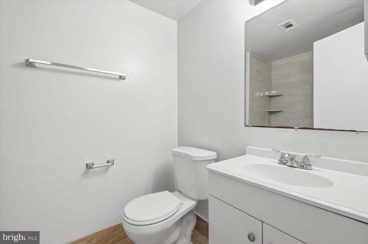 Margate Court, Unit A Sterling, VA 20164 - Photo 10 of 20 a bathroom with a sink a toilet and a mirror
