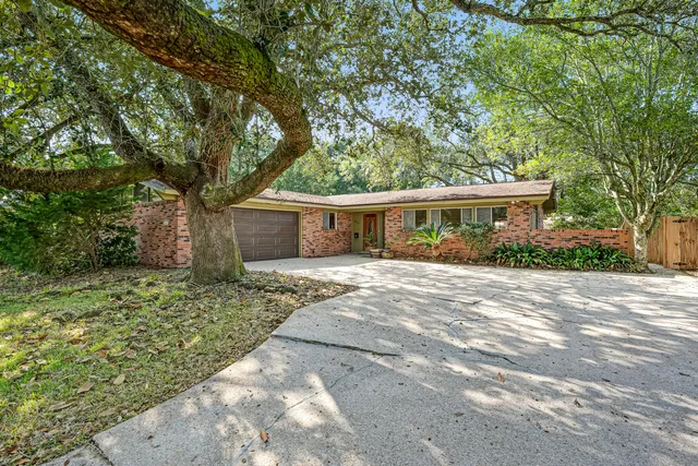 a front view of a house with a yard garage and outdoor seating
