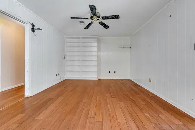 a view of a yard with yellow house