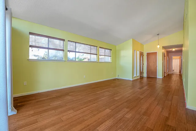 a kitchen with stainless steel appliances granite countertop a refrigerator stove and white cabinets