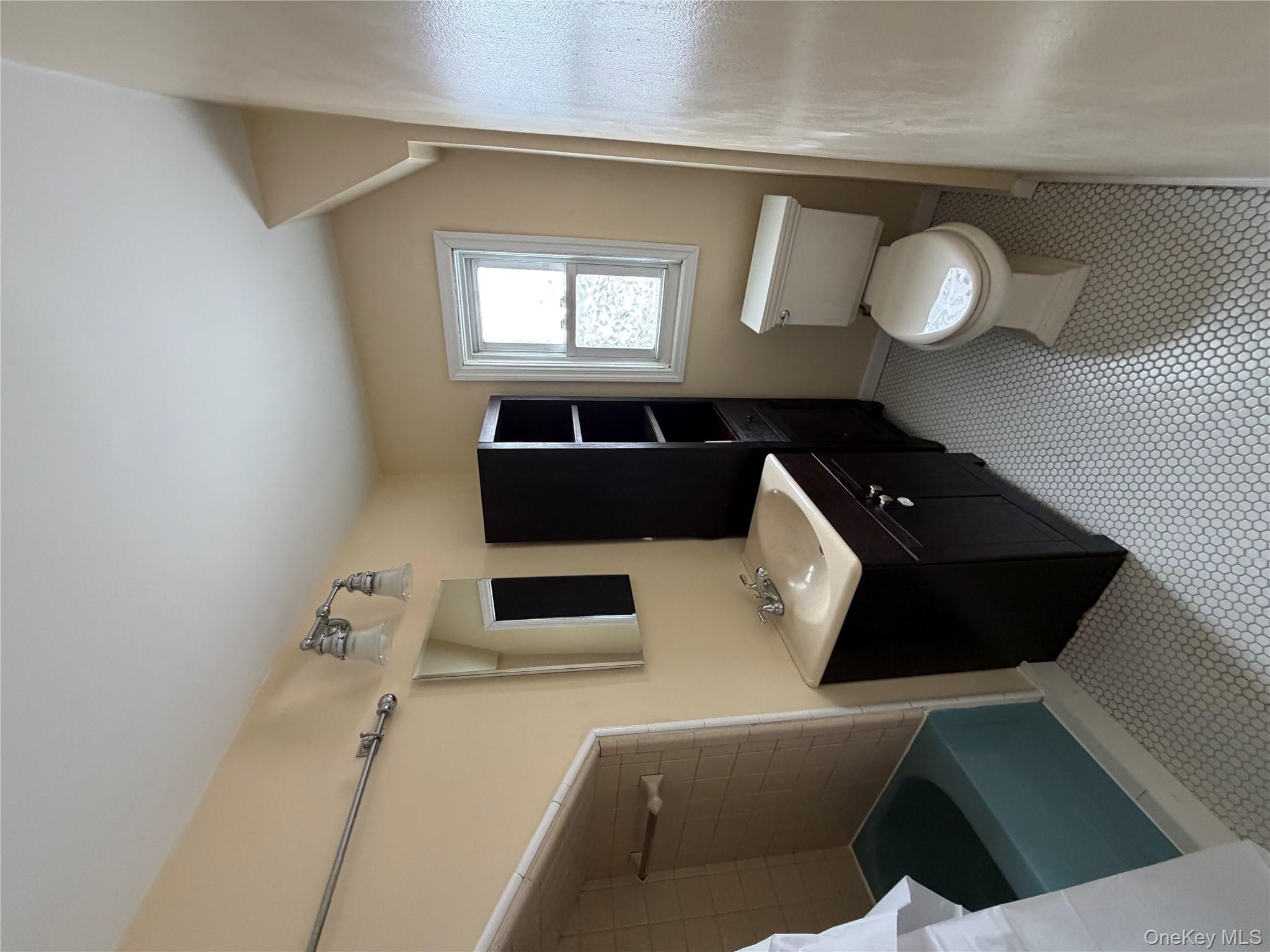 32 Fountain Place, Unit 2 Poughkeepsie, NY 12603 - Photo 15 of 20 a bathroom with a toilet sink and mirror