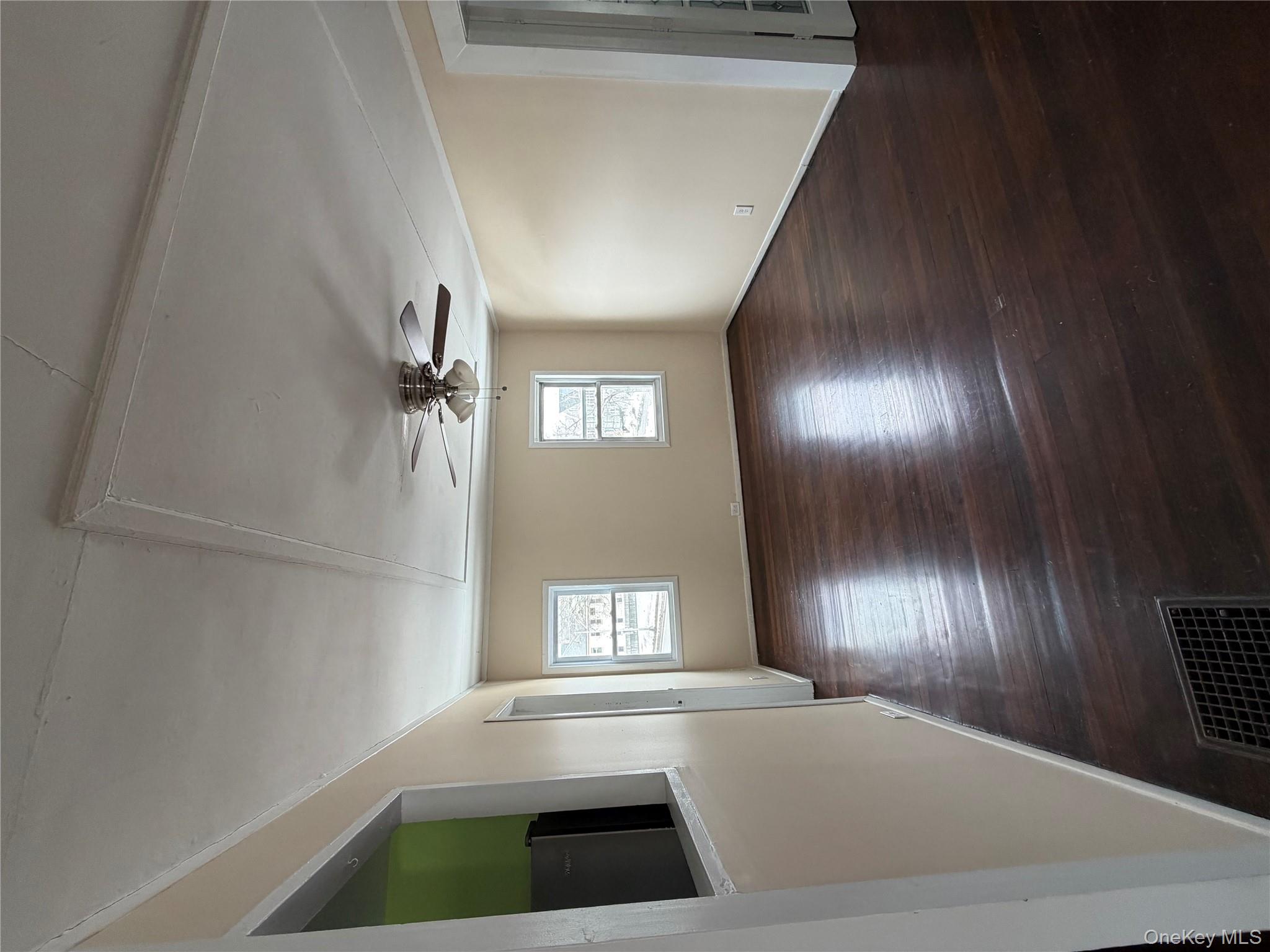 32 Fountain Place, Unit 2 Poughkeepsie, NY 12603 - Photo 17 of 20 an empty room with wooden floor and windows