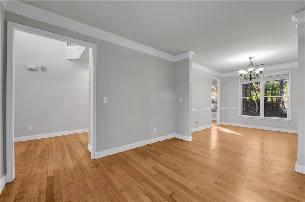 1427 Lost Bridge Road Southwest Marietta, GA 30008 - Photo 13 of 50 an empty room with wooden floor and windows