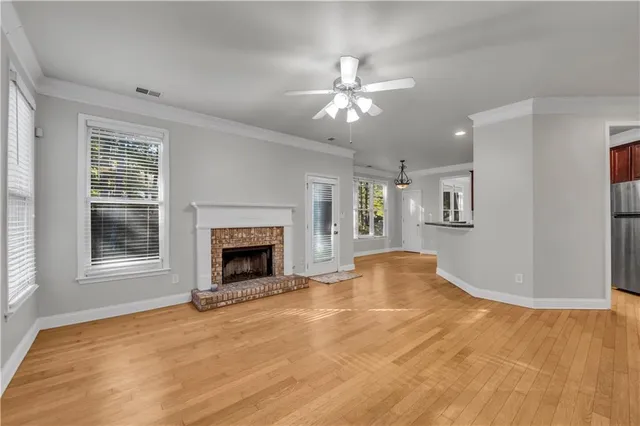 a view of an empty room with window and fireplace