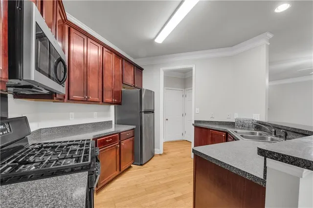 a kitchen with stainless steel appliances granite countertop a stove and a refrigerator