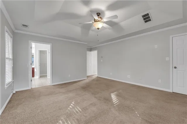 a view of an empty room with a ceiling fan