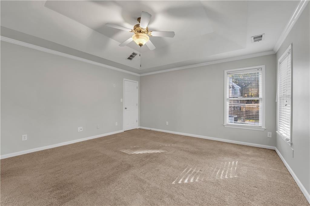 1427 Lost Bridge Road Southwest Marietta, GA 30008 - Photo 34 of 50 an empty room with a chandelier fan and windows