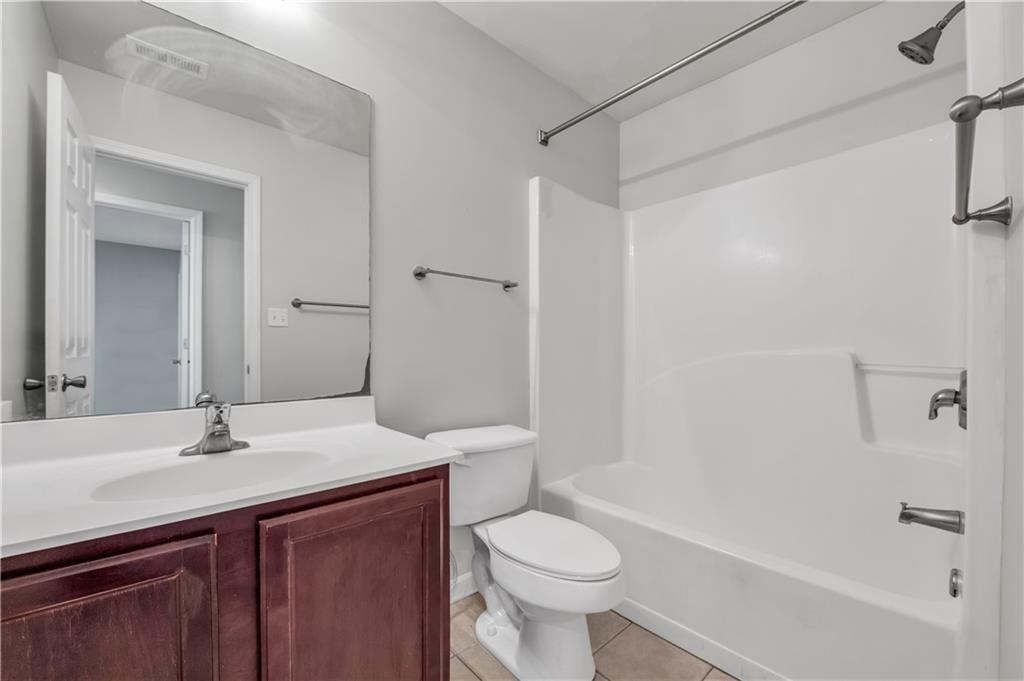 1427 Lost Bridge Road Southwest Marietta, GA 30008 - Photo 42 of 50 a bathroom with a sink a toilet and shower