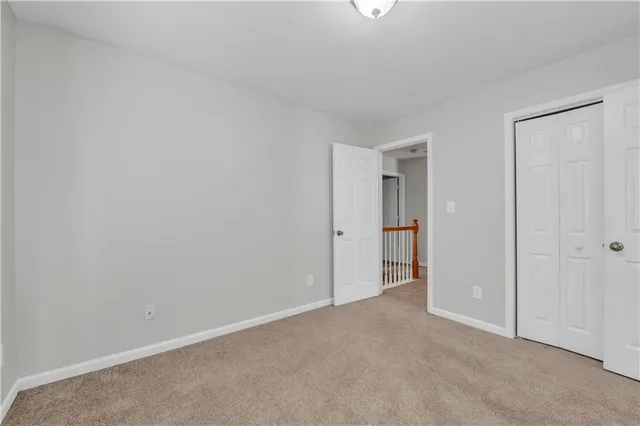 a view of an empty room and closet